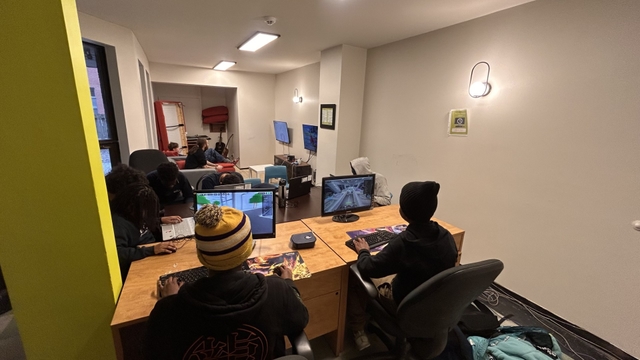 Young people gathered around computers at the centre